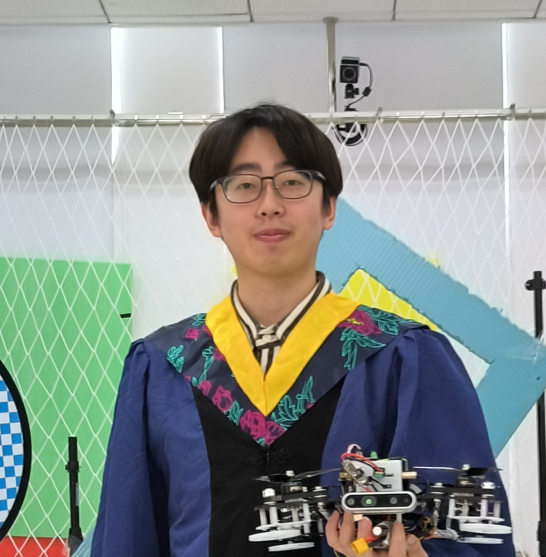 Dongnan Hu holding a hybrid flying-crawling quadrotor
